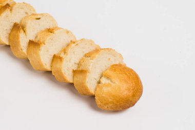 Pieces of crispy delicious French baguette on a white background.