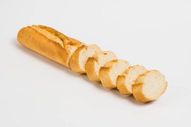 Sliced french baguette on a white background with space for text.