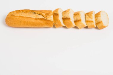 Sliced french baguette on a white background with space for text.