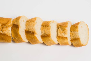 Appetizing French bun crust close-up. Sliced french baguette on a white background with space for text.