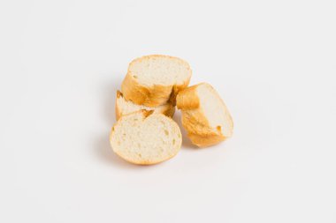 Pieces of French bread, baguette with an appetizing crust, on a white background, macro