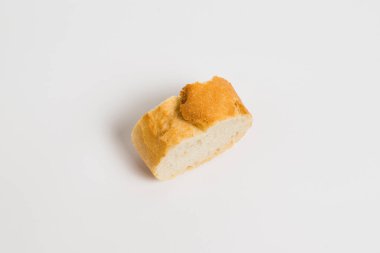 A piece of baguette with an appetizing crust, on a white background, macro. Concept of healthy eating