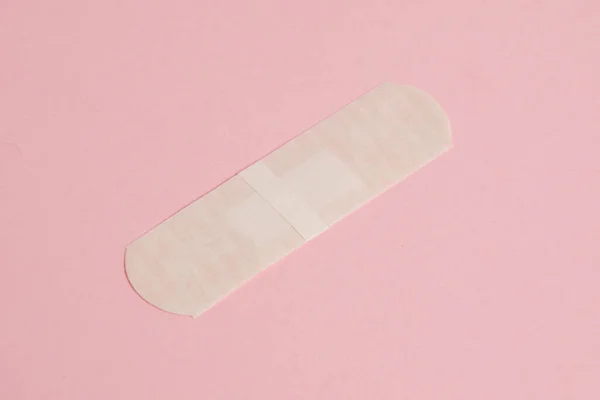 Flatlay, medical bactericidal patch on a pink background.