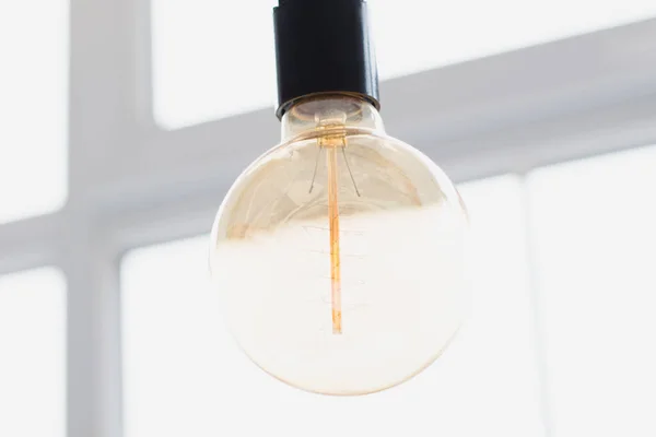 A large, beautiful decorative light bulb for the interior that does not glow. Concept of lack of light in the house.