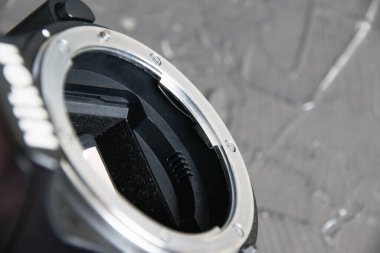 Ukraine, Chernihiv, February 21, 2023: old used photo equipment, a bayonet from an old camera on a gray background.