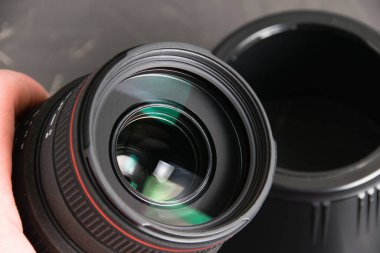 Ukraine, Chernihiv, February 21, 2023 : old Sigma lens with dust and scratches on a gray background.