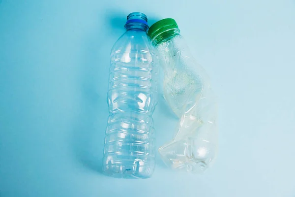 Plastic bottles from drinks on a paper background. Concept of earth day, zero waste and plastic recycling