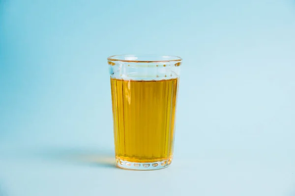 青い紙の背景にジュースのガラス 健康的な食事の概念 — ストック写真