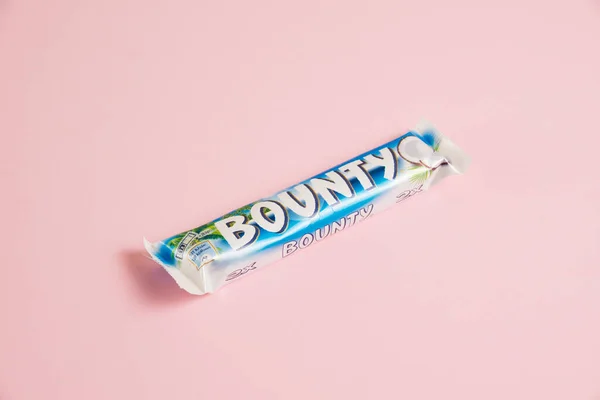 stock image Ukraine, Chernihiv, April 26, 2023: Chocolate bar with coconut flakes Bounty on a pink background.