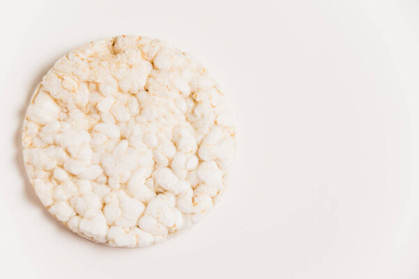 Delicious crispy puffed rice bread on white background with copy space. Diet and healthy eating concept