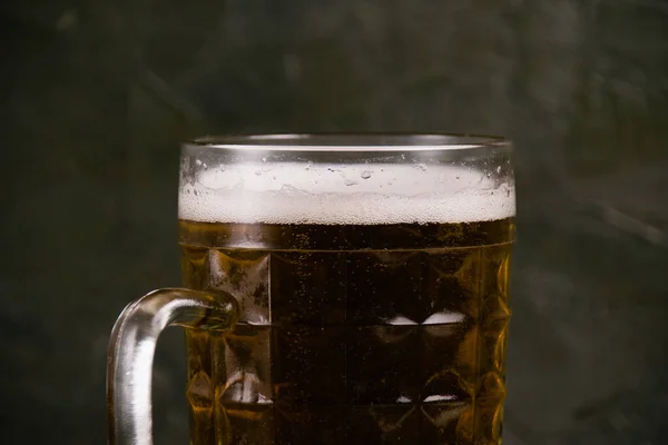 暗い背景にビールマグカップのおいしい軽ビール 白いビール泡のクローズアップ — ストック写真