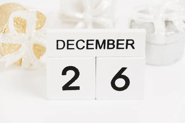 Boxing Day, wooden calendar with the date December 26 and decor on a white background. The concept of preparing for the Christmas and New Year holidays