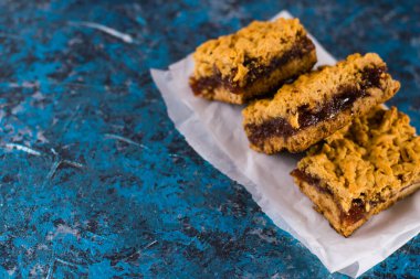 Elma reçelli nefis ev yapımı turta. Parşömen kağıdına reçel sürülmüş, elmalı ve tarçınlı turta parçaları..