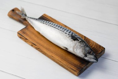 Kesme tahtasındaki çiğ uskumru balığı, balık pişirme..