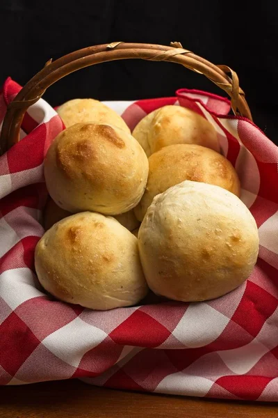 Kırmızı beyaz peçeteli küçük bir sepetin yakın çekimde çekilmiş ev yapımı yemek ruloları..