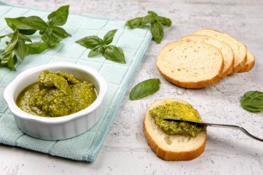 Stüdyoda küçük dilimlere taze pesto serpiştirirken çekilmiş bir fotoğraf..