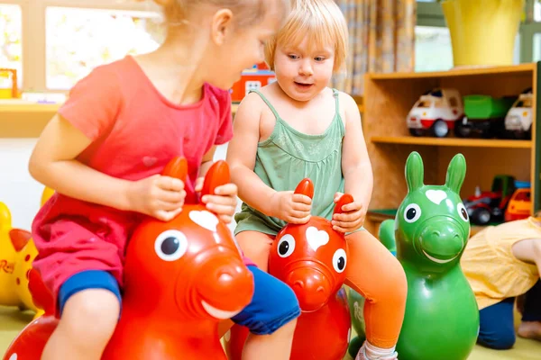Little Girls Riding Red Yellow Play Horses Kindergarten — Stock Photo, Image