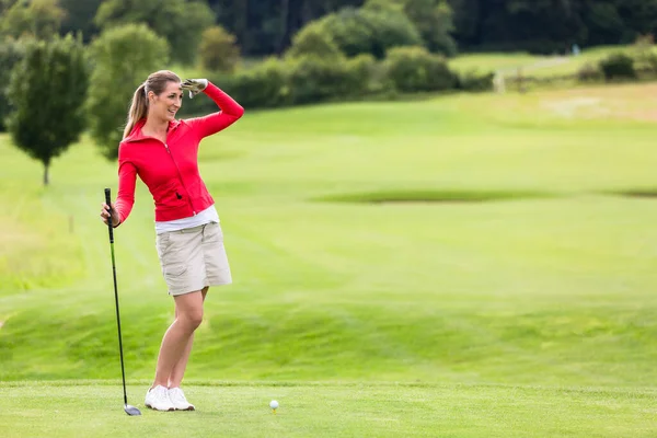 Smiling Attractive Female Golfer Shielding Eyes While Standing Field — Stock Photo, Image
