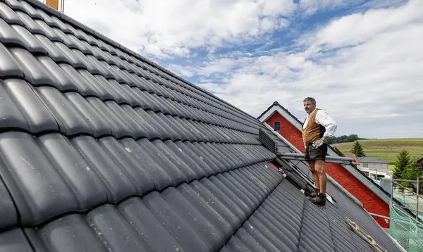 Dachdecker Traditioneller Deutscher Kleidung Eines Handwerkers Der Mit Dachziegeln Auf lizenzfreie Stockbilder