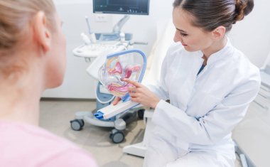 Jinekoloji muayene ile Doktor tıbbi cihazların önünde kadına