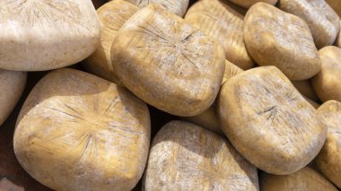 Yürekli el yapımı peynir tekerlekleri belirgin yaşlanma şekilleri sergiliyor.