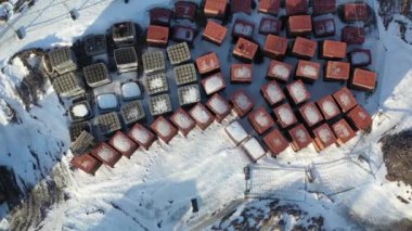 Red and grey paving stones stacks in winter city square, aerial view