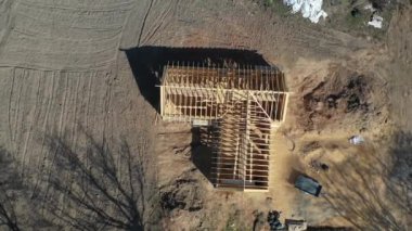 Drone fly up above New Wooden house frame construction, aerial view