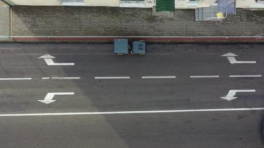 Asphalt road in city repair works with roller tractor, aerial view