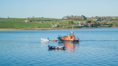 JAN 7, 2024 - CORK, IRELAND. CourtMacSherry Lifeboat is anchored in the river Arigideen. Copy space for text. clipart