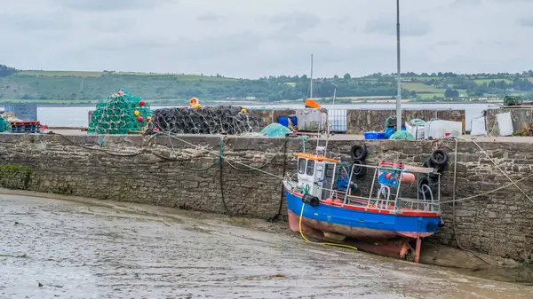 stock image A harbour at low tide with fishing boats anchored.