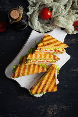 Club sandwich with ham, tomato, green and cheese. Grilled panini. Top view