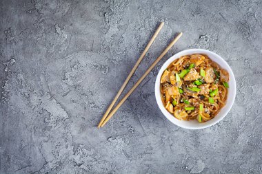 Noodles with vegetables, chicken and mushrooms in bowl. Stir fry pasta. Top view