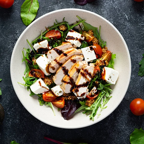 stock image Fresh salad with chicken, tomatoes, herbs and feta cheese. Healthy food. Top view