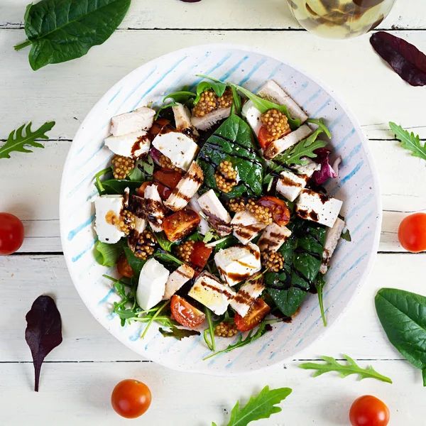 stock image Fresh salad with chicken, tomatoes, herbs and feta cheese. Healthy food. Top view