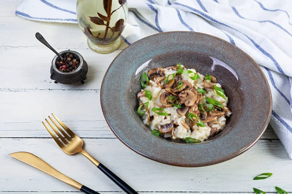 Italian cuisine - risotto with mushrooms. Cooked arborio rice with parmesan cheese and mushrooms