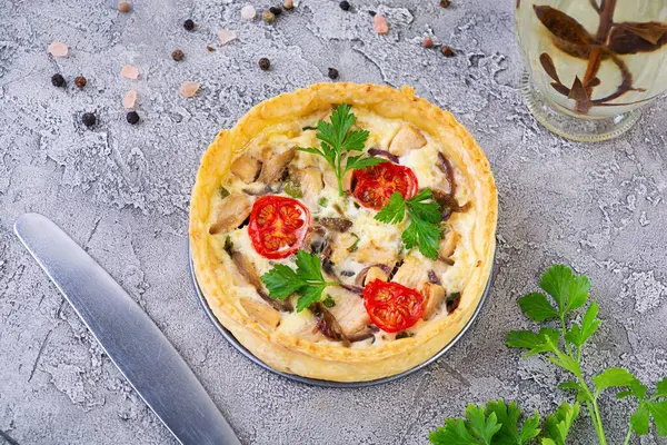 Delicious quiche with chicken meet, mushrooms, tomatoes and herbs