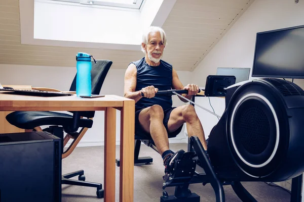 Indoor Portrait Senior Man Working Out His Rowing Machine His Royalty Free Stock Images