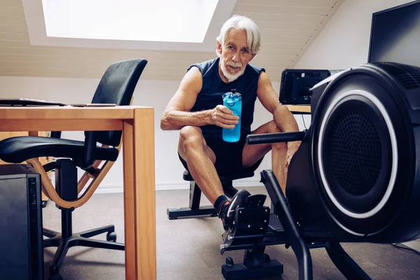 Indoor Portrait Senior Man Working Out His Rowing Machine His Royalty Free Stock Photos