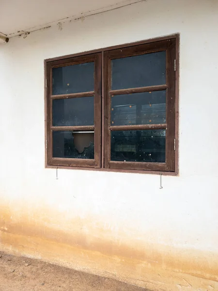 The broken window on the white wall with the water stain after flood, front view for the copy space.
