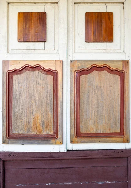 The closed wooden window of the ticket booth of an old train station that is no longer in use, font view with the copy space.