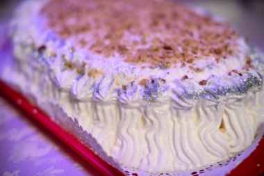 White round cake photographed from multiple angles as well as details in the kitchen where you can see the pastry chef's hands ready to be served to the people clipart