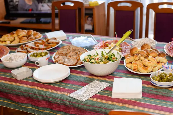 Çeşitli salatalar, mezeler, et, tuzlu hamurdan yapılan çeşitli yemekler yemek masasında servis edilir..