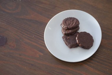 İki tarafı da çikolatalı bisküviler beyaz bir tabakta.