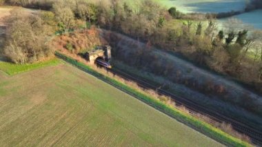 Commuter Train Speeding Through a Tunnel in the Countryside