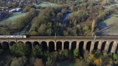 Commuter Train Passing Over a Beautiful Viaduct in the Evening