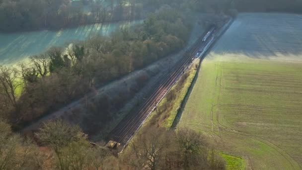 Train Carrying Commuters Speeding Countryside Aerial View — 图库视频影像