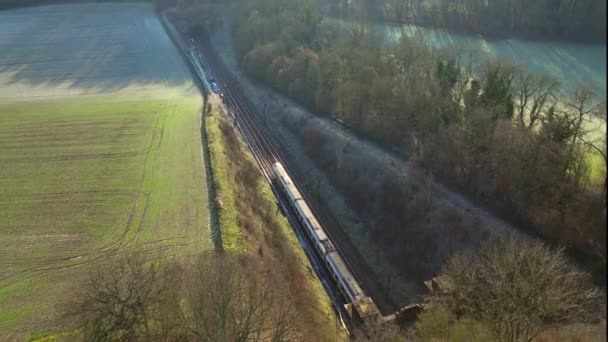 Train Carrying Commuters Speeding Countryside Aerial View — Vídeo de stock