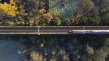 Fast Commuter Train Passing Over a Viaduct Bird's Eye View