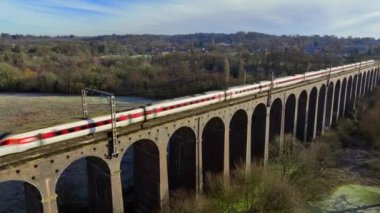 Commuter Train Passing Over a Beautiful Viaduct in the Evening