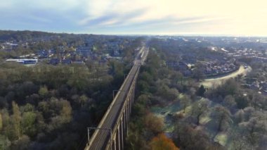 London Commuter Train in the UK Crossing a Viaduct in the Evening